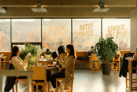 A participant reading a book in a café in the morning